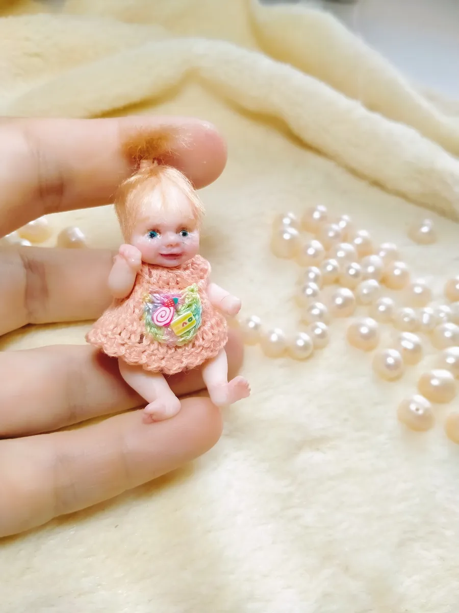 OOAK miniature toddler doll with auburn red hair and blue eyes, wearing peach crocheted dress with flower embellishment - by Mini Baby Dolls