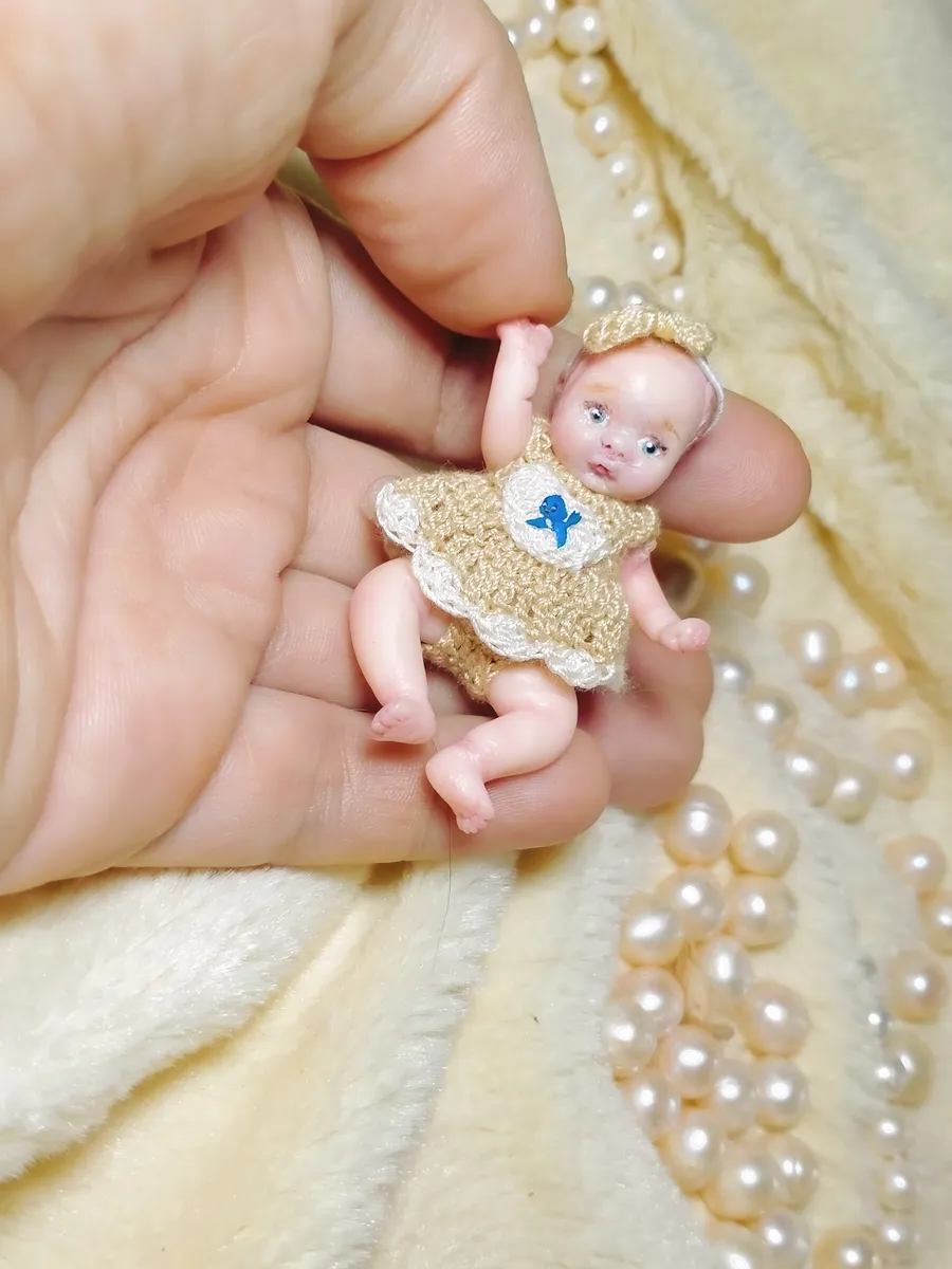OOAK miniature baby doll in golden tan crocheted sweater and headband, displayed with pearl beads - by Mini Baby Dolls
