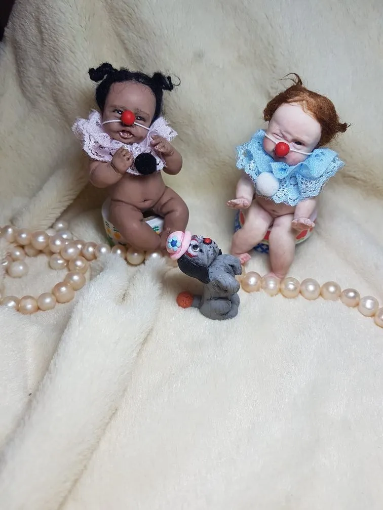 Two playful OOAK miniature clown baby dolls with red noses and lace collars in pink and blue, sitting with tiny sculpted dog toy - by Mini Baby Dolls