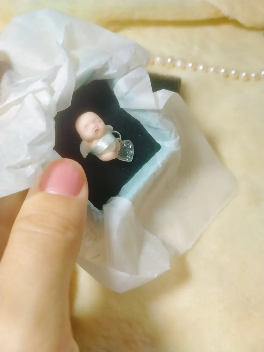Precious OOAK miniature baby doll in elegant gift box with tissue paper, wearing silver wings and heart charm pendant - by Mini Baby Dolls
