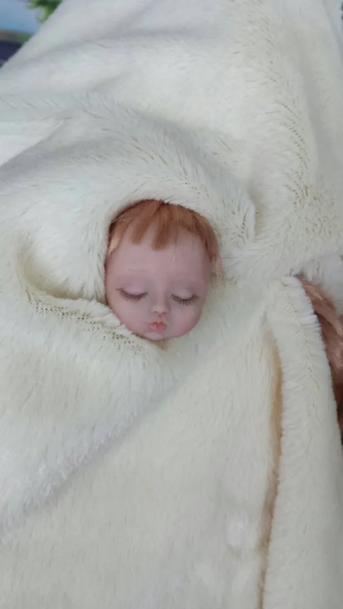 Hyper-realistic sleeping OOAK miniature reborn style baby doll wrapped in white blanket, showing exquisite detail - by Mini Baby Dolls
