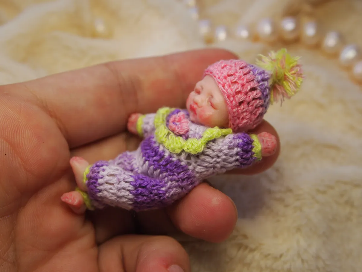 Sleeping OOAK miniature baby doll in colorful purple and green striped crocheted outfit with pink hat - by Mini Baby Dolls