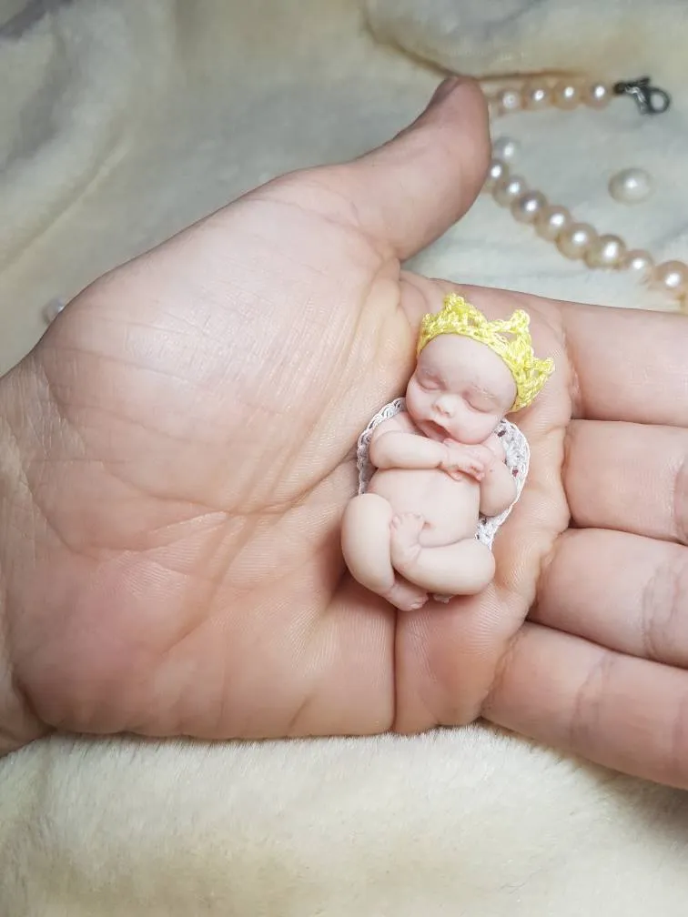 Regal OOAK miniature baby doll wearing a delicate yellow crocheted crown, sleeping peacefully in palm with pearl beads - by Mini Baby Dolls