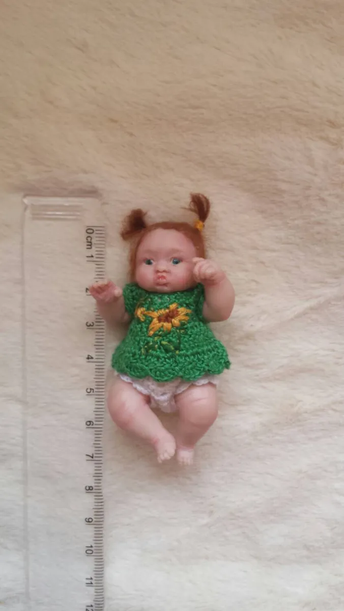 Detailed OOAK miniature toddler doll in green sunflower dress with pigtails, shown next to ruler for scale reference - by Mini Baby Dolls